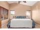 Bright primary bedroom with plush carpeting, vaulted ceilings, and natural light at 44454 W Oster Dr, Maricopa, AZ 85138