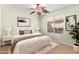 Cozy bedroom offering a plush bed, side tables with lamps, and a window at 44454 W Oster Dr, Maricopa, AZ 85138