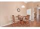 Cozy dining area features modern light fixture, a round wood table, and space for four at 44454 W Oster Dr, Maricopa, AZ 85138