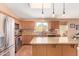 Bright kitchen features granite countertops, island and stainless steel appliances at 44454 W Oster Dr, Maricopa, AZ 85138