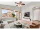 Bright living room featuring french doors to the backyard and a modern ceiling fan at 44454 W Oster Dr, Maricopa, AZ 85138