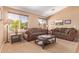 Bright living room with comfortable seating, carpet flooring, and large windows for ample natural light at 44454 W Oster Dr, Maricopa, AZ 85138