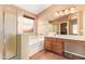 Bright bathroom featuring a soaking tub, step-in shower, and large vanity at 44454 W Oster Dr, Maricopa, AZ 85138