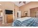 Well-lit main bedroom with carpeting and access to the ensuite bath at 44454 W Oster Dr, Maricopa, AZ 85138