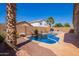 Backyard pool area with brick walls, desert landscaping and a partial pool cover on the sparkling blue water at 44454 W Oster Dr, Maricopa, AZ 85138
