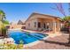 Backyard pool with sunny patio and desert landscaping, perfect for relaxing and enjoying the outdoors at 44454 W Oster Dr, Maricopa, AZ 85138