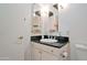 A bathroom features a sink with a black granite countertop and a mirror at 4750 N Central Ave # D15, Phoenix, AZ 85012
