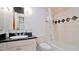 Bathroom with a shower-tub combo, a sink with black granite countertop, and neutral tiling at 4750 N Central Ave # D15, Phoenix, AZ 85012