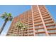 A high rise building with palm trees, under a clear blue sky at 4750 N Central Ave # D15, Phoenix, AZ 85012
