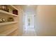 Bright hallway with white tile floor, leading past built-in shelves and doorways at 4750 N Central Ave # D15, Phoenix, AZ 85012