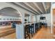 Spacious recreation room with lounge seating, bar with seating, and natural wood floors at 4750 N Central Ave # D15, Phoenix, AZ 85012