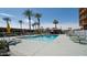 Community pool featuring multiple lounge chairs, a picnic shelter, and lush landscaping at 4750 N Central Ave # D15, Phoenix, AZ 85012