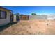 Fenced backyard leads to a gate and a block wall perimeter, offering privacy and security at 4870 W Almeria Rd, Phoenix, AZ 85035