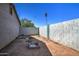 Enclosed backyard has block wall, sparse desert vegetation, and an area to build a firepit at 4870 W Almeria Rd, Phoenix, AZ 85035