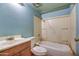 Dated blue bathroom with a shower-tub combo and stained vanity at 4870 W Almeria Rd, Phoenix, AZ 85035