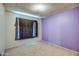 A purple bedroom with a sealed window and textured ceiling at 4870 W Almeria Rd, Phoenix, AZ 85035