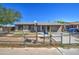 Modest single-story home with desert landscaping and a chain link fence needs some TLC at 4870 W Almeria Rd, Phoenix, AZ 85035