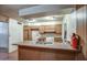 Open kitchen area with vintage wood cabinets and basic appliances, in need of renovation at 4870 W Almeria Rd, Phoenix, AZ 85035