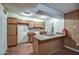 Modest kitchen area featuring wood cabinetry and countertop with a sink at 4870 W Almeria Rd, Phoenix, AZ 85035