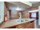 Kitchen area featuring wood cabinetry and countertop with a stainless steel sink at 4870 W Almeria Rd, Phoenix, AZ 85035