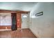 Living room with hardwood floors and a view of the front door, in need of renovation at 4870 W Almeria Rd, Phoenix, AZ 85035