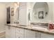 Bathroom featuring dual sinks with decorative granite counters at 4915 W Libby St, Glendale, AZ 85308