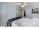 Bedroom with blue walls featuring a ceiling fan and a sliding door closet at 4915 W Libby St, Glendale, AZ 85308