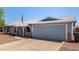 Charming single-story home with a two-car garage, light blue exterior, and well-kept front yard at 4915 W Libby St, Glendale, AZ 85308