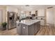 Modern kitchen featuring white cabinets, a gray island, stainless steel appliances, and lots of natural light at 4915 W Libby St, Glendale, AZ 85308