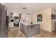 Bright kitchen with stainless steel appliances, light countertops, white and gray cabinets, and a large island at 4915 W Libby St, Glendale, AZ 85308