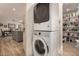 Convenient laundry area with stacked washer and dryer next to a pantry with ample shelving at 4915 W Libby St, Glendale, AZ 85308