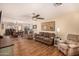 Open-concept living room with hardwood floors, a ceiling fan, and comfortable seating at 4915 W Libby St, Glendale, AZ 85308