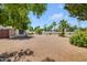 Expansive backyard with lush landscaping, mature trees, and meticulous desert landscaping at 511 E Calavar Rd, Phoenix, AZ 85022