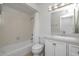 Well-lit bathroom features a shower-tub combo, a granite-style countertop vanity, and neutral tile at 511 E Calavar Rd, Phoenix, AZ 85022