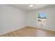 Light and bright bedroom with hardwood floors and a large window view to the outdoors at 511 E Calavar Rd, Phoenix, AZ 85022