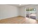 Bright bedroom with hardwood floors and sliding glass door to a private outdoor patio at 511 E Calavar Rd, Phoenix, AZ 85022