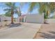 Inviting single-story home featuring a white exterior, tile roof, and well-maintained gravel landscaping at 511 E Calavar Rd, Phoenix, AZ 85022