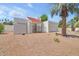 Cozy single-story home featuring a white exterior, tile roof, and low maintenance gravel landscaping at 511 E Calavar Rd, Phoenix, AZ 85022