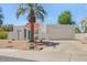 Charming single-story home featuring a white exterior, a vibrant blue front door and well-maintained landscaping at 511 E Calavar Rd, Phoenix, AZ 85022