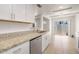 Bright kitchen features white cabinetry, stainless appliances, and granite countertops at 511 E Calavar Rd, Phoenix, AZ 85022