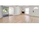 Bright living room with fireplace, sliding glass doors, neutral walls, and light wood-look floors at 511 E Calavar Rd, Phoenix, AZ 85022