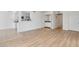 Open-concept living area with light, bright walls, modern flooring, and seamless flow into the kitchen space at 511 E Calavar Rd, Phoenix, AZ 85022