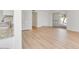 Bright living space featuring modern flooring, white walls, and seamless flow from kitchen to outdoor area at 511 E Calavar Rd, Phoenix, AZ 85022