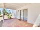 Outdoor patio space with brick-style flooring, seamlessly connected to a sliding glass door at 511 E Calavar Rd, Phoenix, AZ 85022