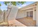 Enclosed patio area featuring brick-style flooring with access to the landscaped yard at 511 E Calavar Rd, Phoenix, AZ 85022