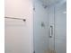 Bathroom shower stall with clear glass doors and white tile surround at 511 E Calavar Rd, Phoenix, AZ 85022