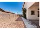 View of the backyard featuring a wall, walkway, and landscaping with decorative rock at 5322 N Oro Vista Ct, Litchfield Park, AZ 85340