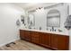 Bathroom features a double vanity, modern lighting, and hardwood floors at 5322 N Oro Vista Ct, Litchfield Park, AZ 85340