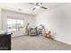 Bright bedroom with ceiling fan, window, rocking horse, plush giraffe, and plenty of toys at 5322 N Oro Vista Ct, Litchfield Park, AZ 85340