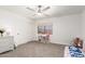 Light and bright bedroom featuring carpet, ceiling fan, window, and toy storage at 5322 N Oro Vista Ct, Litchfield Park, AZ 85340